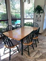 Full view of dining table set with leaf inserted and six chairs around