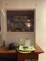 Full view of American Girl Mini lighted display cabinet with drawer and accessories