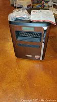 Front view of the Pure Heat portable electric space heater showing air vents, digital control panel, and branding labels.