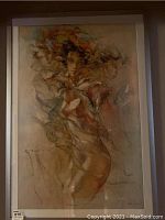 Full view of the framed artwork showing the feminine figure and abstract elements in earth tones with highlighted hair.