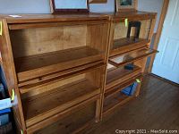 Viewing two oak barrister bookcases side by side with glass front doors lifted open on right unit
