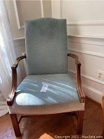 Front view of Southwood armchair showing cloth seat and back in light blue-grey fabric with wooden arms and legs.