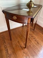 Front three-quarter view showing tabletop, drop leaves, drawer and overall condition