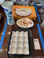 Overview of vase, egg platter, oyster plates, egg trays, and plastic tray on table