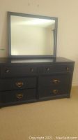 Front view of the black 6 drawer dresser with matching black framed mirror on top.