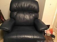 Front view showing overall chair shape, padded arms, backrest and seat