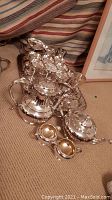 Overview of the full silver plated tea and coffee service including pot, creamer, sugar bowl, wine coaster, and tray.