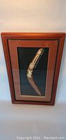 Framed boomerang with Aboriginal dot painting art and wooden frame