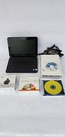 Photo showing all items: mini laptop, LG DVD writer, Chromecast box, DVD-R spindle, and software disks