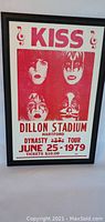Full front view of framed KISS concert print with band member artwork and event details.