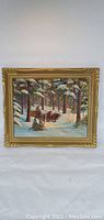 Full front view of framed winter landscape oil painting on canvas by Marguerite W. Boyce showing horse-drawn sleigh and snow-covered trees.