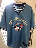 Front view of the mid-2000s Alex Rios Toronto Blue Jays light blue retro baseball jersey showing team name and logo.