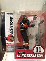 Original packaged Daniel Alfredsson hockey figurine in Ottawa Senators uniform, showing front and side packaging details.