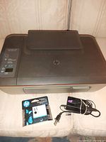 HP colour printer scanner top view showing control panel, HP logo, and top output tray.