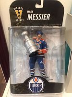Photo of Mark Messier figurine in sealed original Vintage Hockey packaging, showing front details and Stanley Cup trophy held by figure.
