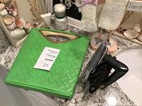Green vintage mechanical bathroom scale with basket-weave pattern, small decorative vintage black iron next to it.