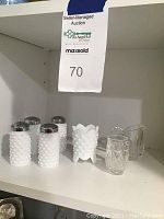 Four milk glass hobnail salt and pepper shakers and three toothpick holders (two clear glass, one milk glass) displayed on shelf