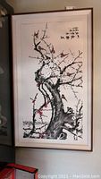 Full view of framed Chinese style watercolor painting showing the overall composition with tree branch, blossoms and birds.