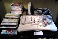 Full view of Wii console, balance board, controllers, headphones and cables