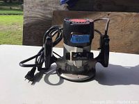 Front view of Craftsman router with power cord and handles visible.