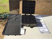 Overall setup showing waffle maker with waffle plates attached and pancake/griddle plate beside, manuals laid out
