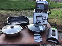 Overview of all items: Dualit toaster, Calphalon cookware including covered Dutch oven, roasting pan with rack, non-stick frying pan, and bag saver.