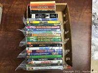 Box containing DVDs and some audiobooks stacked vertically showing titles.