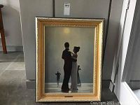 Frontal view of framed picture showing a dancing couple silhouette under a moonlight with detailed gold and grey frame.