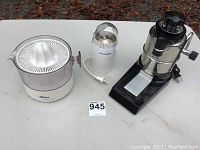 Photo showing three small kitchen appliances side by side on a white surface: Oster citrus juicer, Proctor-Silex coffee grinder, Progressive food chopper.