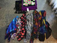 Seven colorful scarves laid flat showing diverse prints and textures.