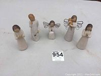 Front angle photo showing five figurines together revealing designs and scale.