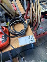 Workbench surface with electrical cords and a vendor lot tag visible