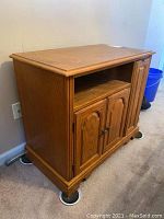 Wooden TV cabinet front and right side showing vertical drawer, open shelf, and double cabinet doors