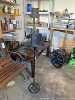 Full view of the metal detector standing upright in a garage with control box and circular coil visible.