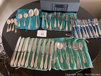 Full overview of all flatware pieces organized on storage rolls