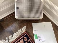 View of one white A/D/S speaker front grill with original documentation and auction lot tag visible on floor