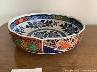 View of the octagonal decorative porcelain bowl showing varied floral patterns on inside and outside.