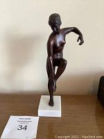 Front view of the bronze figure and marble base