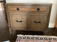 Front view showing top drawer and cabinet doors