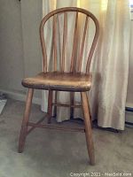 Front view of antique pine hoop back chair showing curved backrest and seat