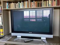 Front view of Panasonic 40-inch plasma TV powered off, showing a large screen with a black border and silver lower section with speaker grille.