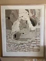Front view of framed serigraph depicting desert stone ruins