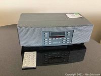 Front view of Model 88 radio with remote placed on table, showing overall device and remote