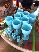 All eight goblets and four cordial glasses arranged on glass patio table