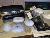 FoodSaver V3250 vacuum sealer and vacuum-storage containers arranged on countertop