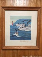 Framed print showing Little Toot with larger steamboats and Golden Gate Bridge in background, mounted in a wooden frame.