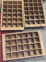 Top down view of three wooden wine bottle case boxes showing compartments