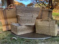 Full view of the set showing three lined rectangular woven baskets and one large southwestern style woven bag with handles and stripes
