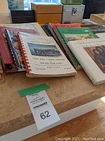 Cookbooks and recipe boxes on table with auction lot tag