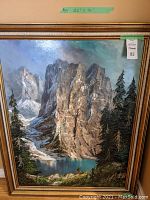 Front view of framed oil painting showing mountain scene and frame